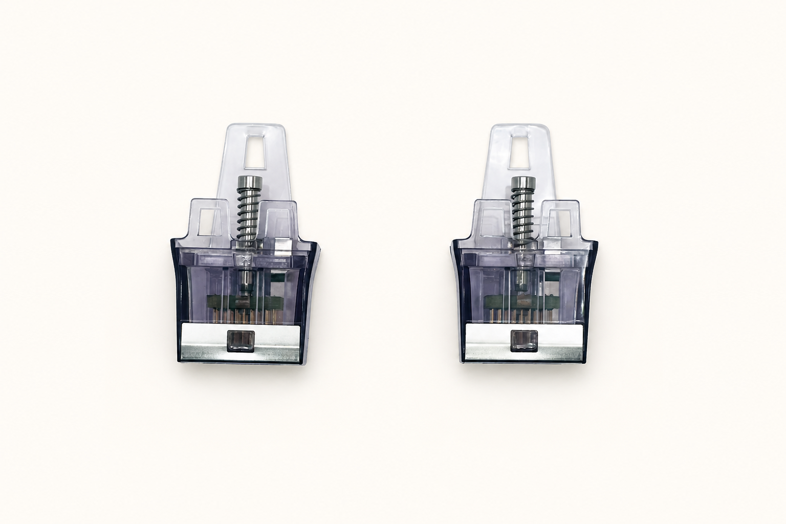 Two transparent purple-gray cartridge components shown from the front on a plain studio background.